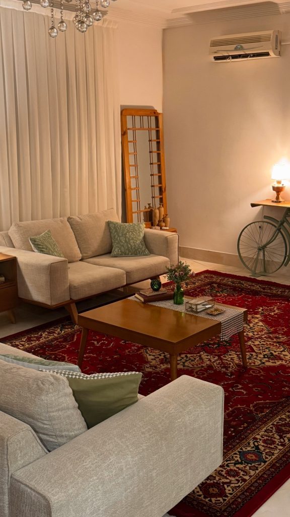 Ground Neutral Sofas with a Red Persian-Style Rug