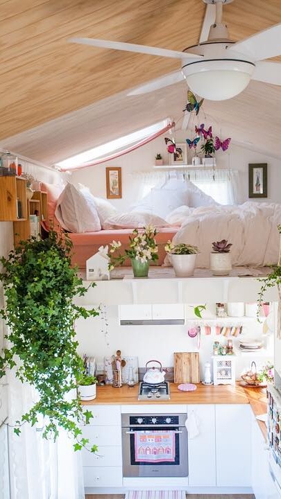Let Trailing Plants and Soft Pink Warm Up an All-White Tiny Home